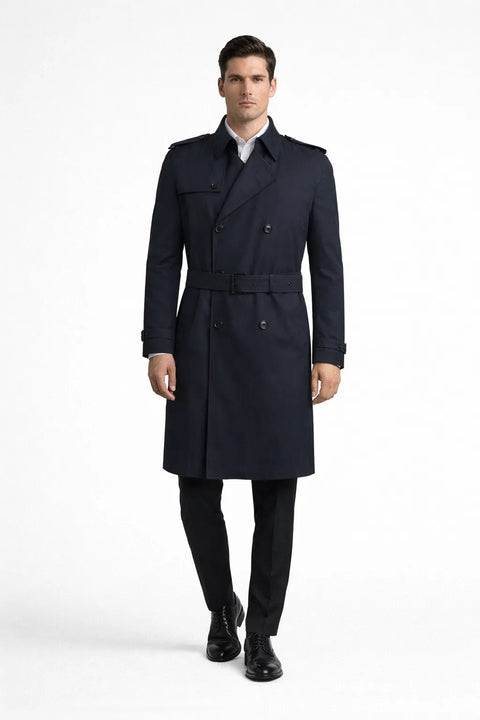 Man wearing a navy trench coat on a white background