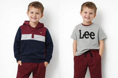 Two children wearing matching outfits with maroon pants and hoodies on a white background