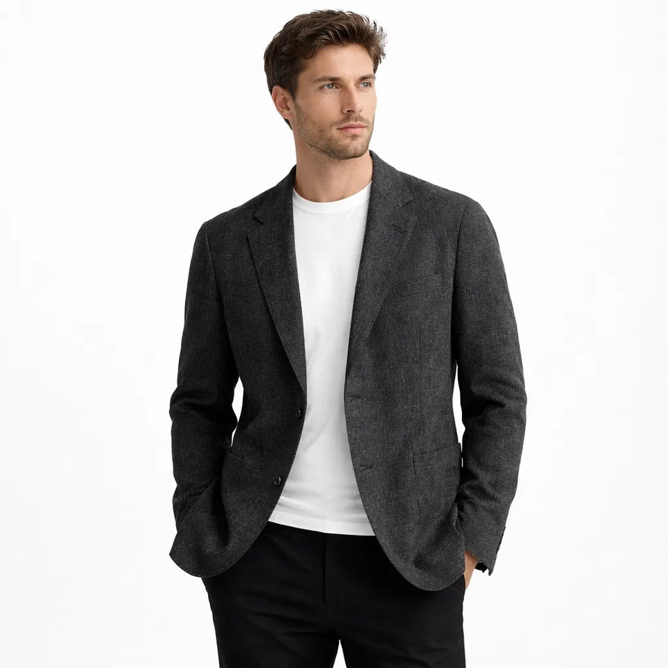 Man wearing a gray blazer over a white shirt on a white background