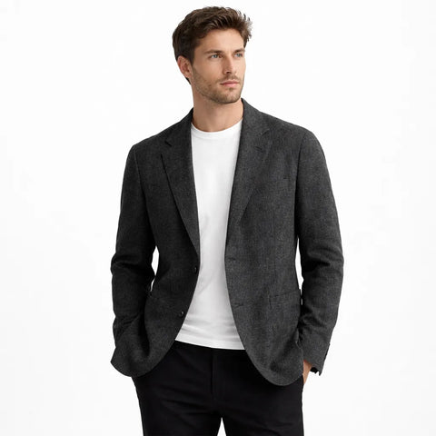 Man wearing a gray blazer over a white shirt on a white background