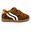 A toddler's low-top sneaker featuring a brown and black leopard print pattern, a white side stripe, two hook-and-loop straps, and a brown rubber sole, shown against a plain white background.