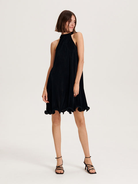 Woman wearing a black dress on a white background
