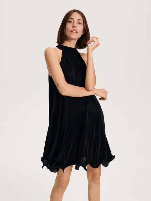 Woman wearing a black dress on a white background
