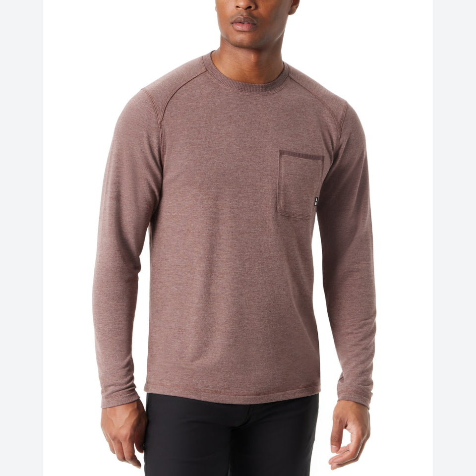 A man wearing a heathered brown long-sleeve crewneck shirt with a chest pocket, paired with black pants, against a plain white background.