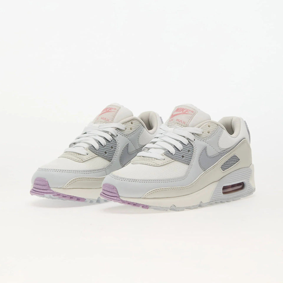 A pair of Nike Air Max 90 sneakers in light gray, off-white, and lavender purple, shown from the side on a clean white background.