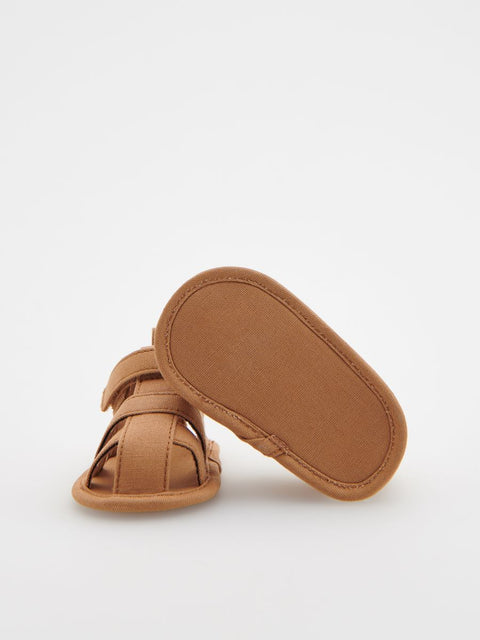 Brown baby sandals on a white background