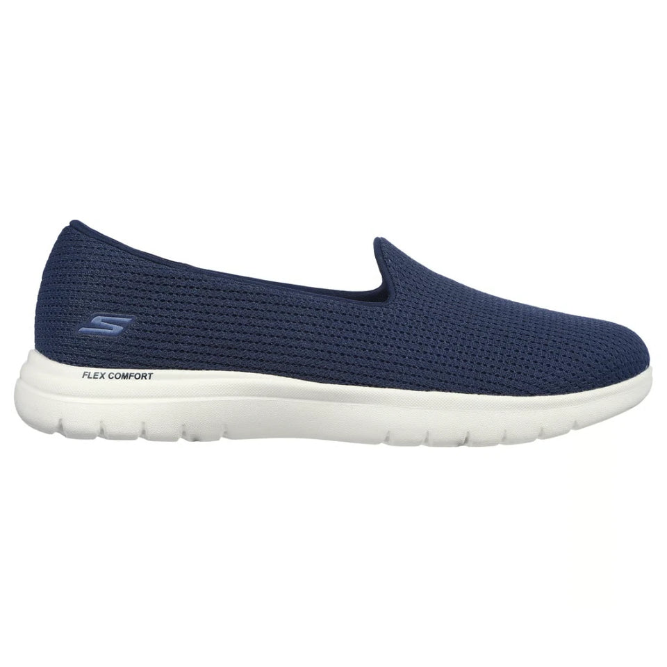 A navy blue slip-on walking shoe with a textured mesh upper and a white sole, shown in a side profile view against a white background.