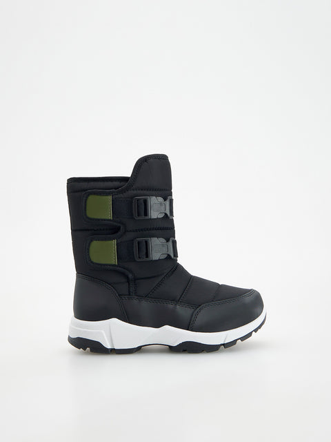 Black winter boot with white sole on a white background