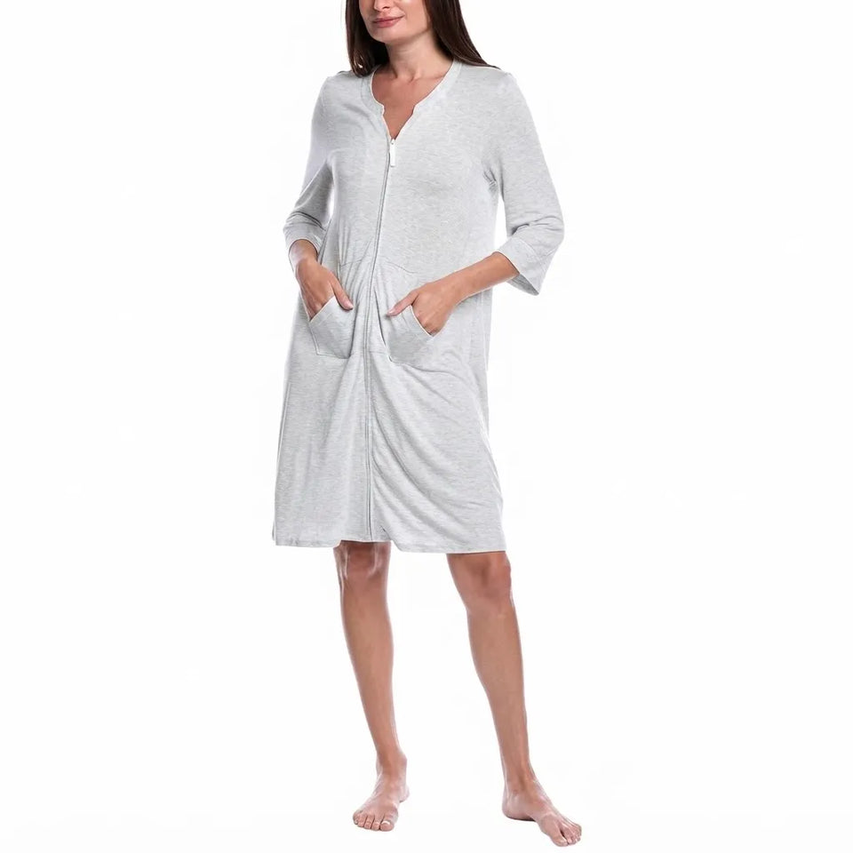 A woman modeling a light gray heathered zip-up robe with three-quarter sleeves and front pockets, shown against a plain white background.