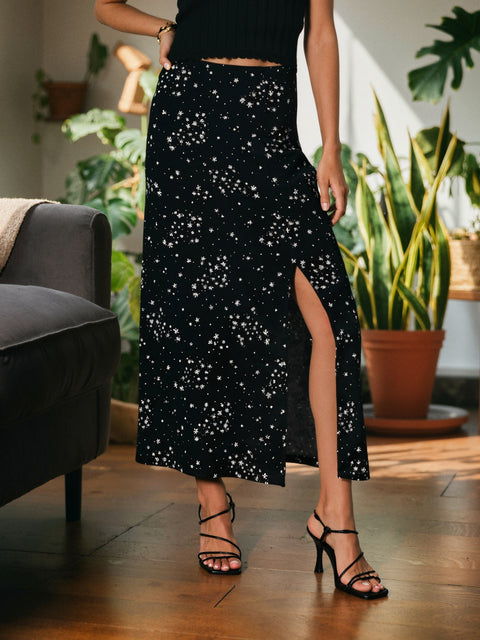 Person wearing a black sequin skirt in a home setting with plants and furniture.