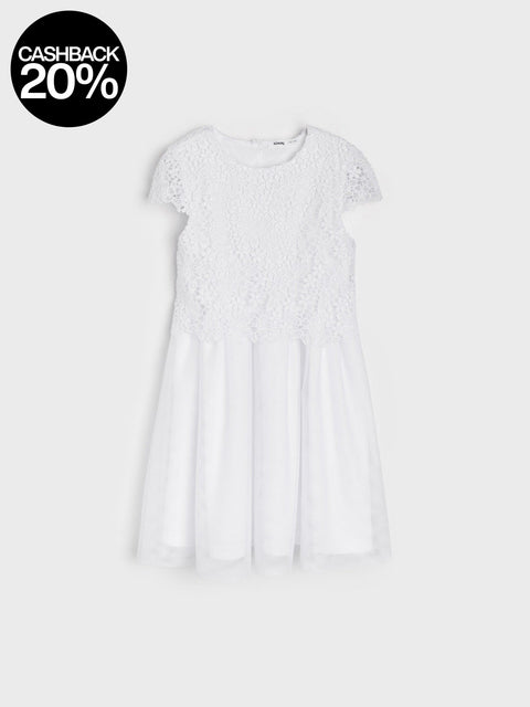 White dress with lace details on a light gray background