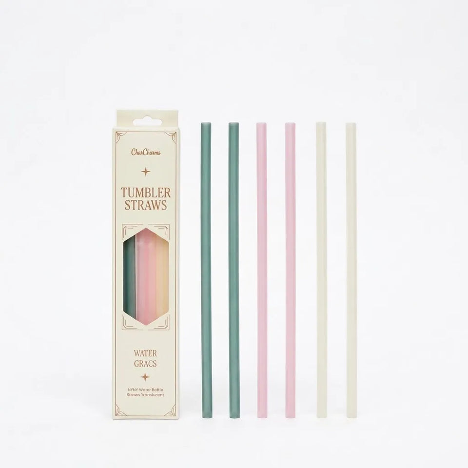 A set of six pastel-colored tumblers straws displayed next to their cream-colored packaging box on a clean white background. The straws come in shades of teal green, dark green, light pink, soft pink, pale yellow, and off-white.