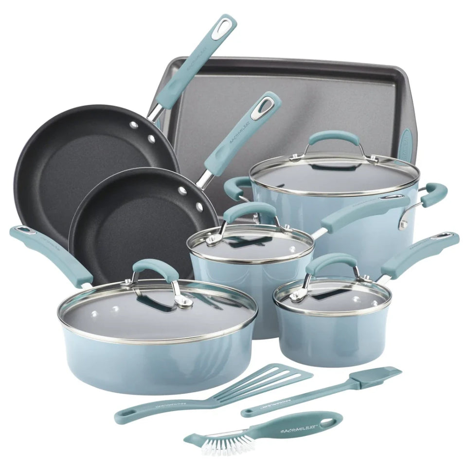 A 15-piece kitchen cookware set in a light blue color with stainless steel interiors and handles, including pots, pans, lids, a baking sheet, and utensils, arranged on a white background.