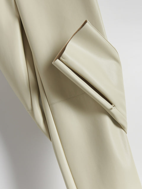 Close-up of a beige suit jacket with a pocket on a light gray background