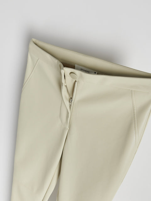 Beige pants with a zipper on a light gray background