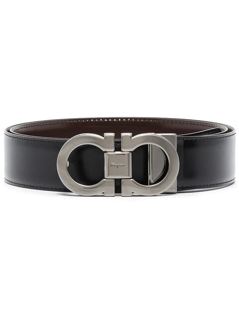Black leather belt with silver buckle on a white background