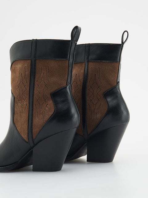 Pair of black and brown ankle boots on a white background