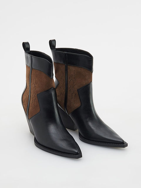 Black and brown leather ankle boots on a white background