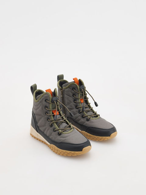 Pair of gray and green boots on a white background