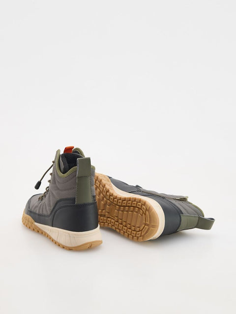 Pair of gray and green hiking boots on a white background
