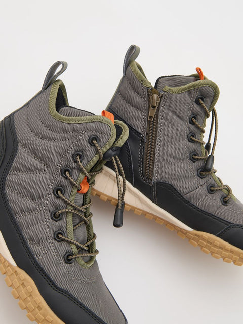 Gray hiking boots with orange accents on a white background