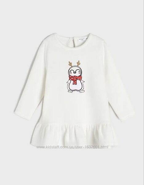 White dress with a cartoon penguin design on a white background