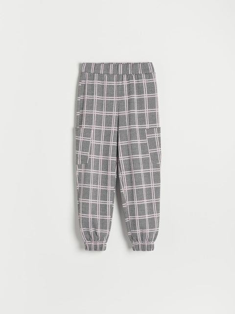 Plaid pants on a light gray background