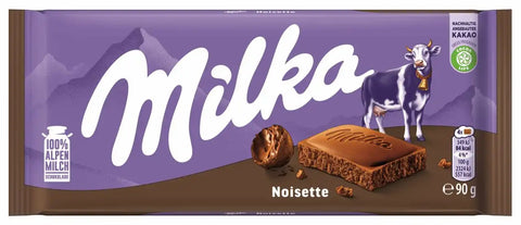 Milka Noisette chocolate bar packaging with a cow illustration on a purple and brown background