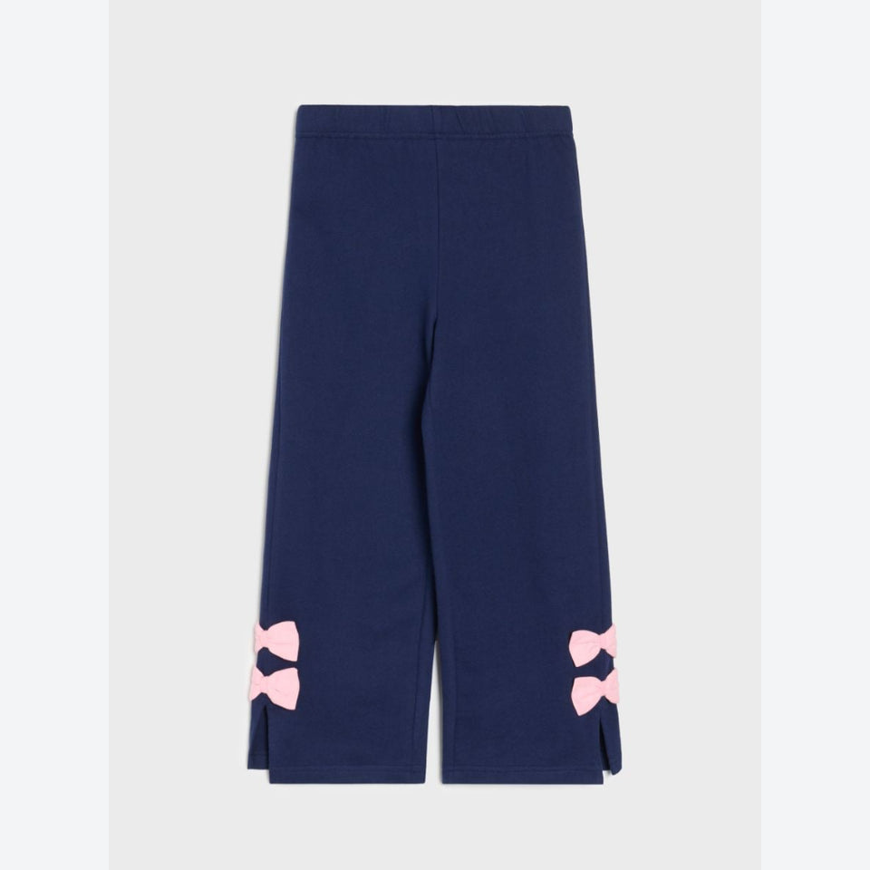 Navy blue wide-leg cropped pants with pink bow details on the lower hems, shown flat against a light gray background.