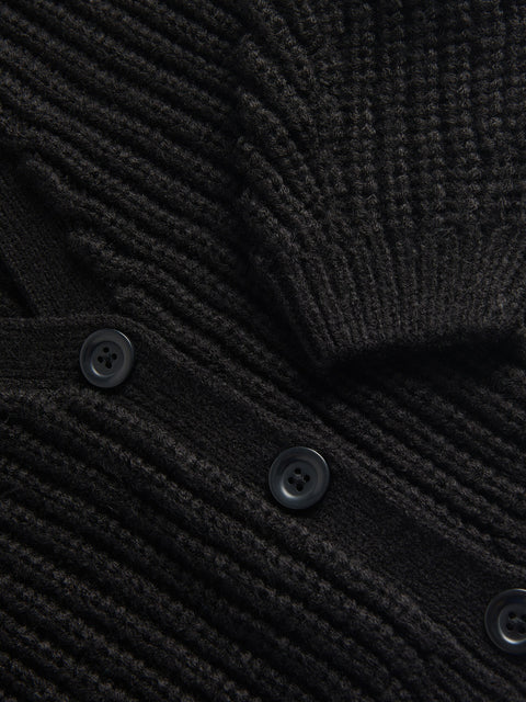 Close-up of a black textured sweater with buttons