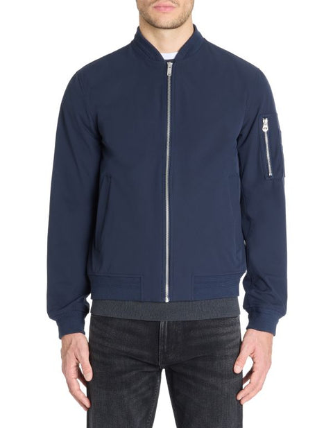 Navy blue bomber jacket worn by a person on a white background
