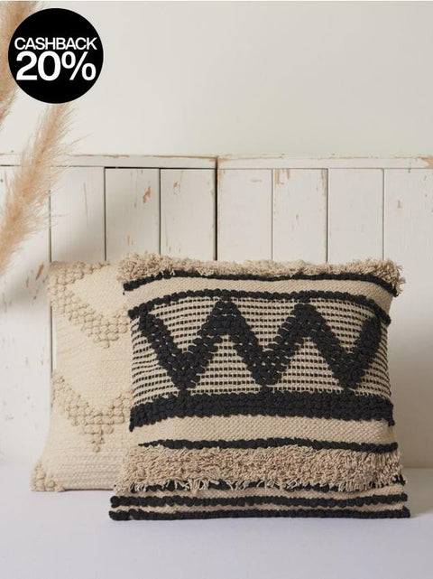 Textured pillows with geometric patterns on a wooden background