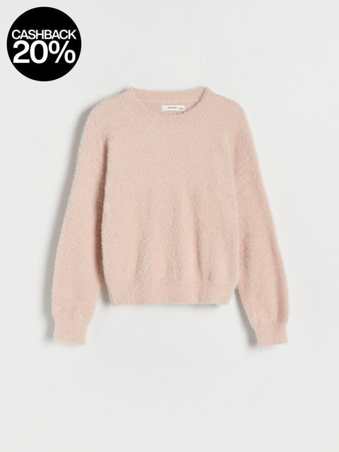 Pink sweater on a light gray background
