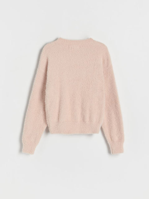 Light pink sweater on a light gray background