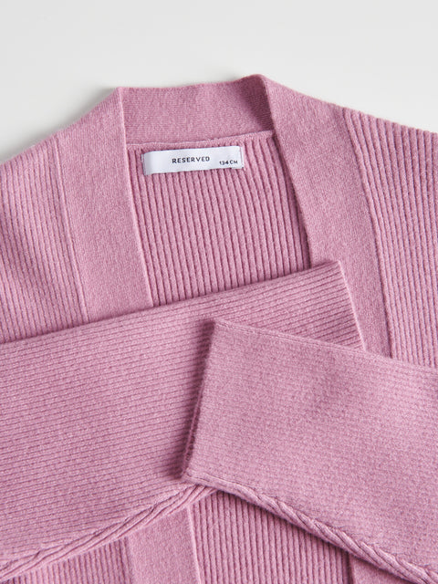 Pink sweater with 'RESERVED' label on a light gray background