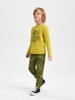 Child wearing a yellow long-sleeve shirt and green pants with text on a white background