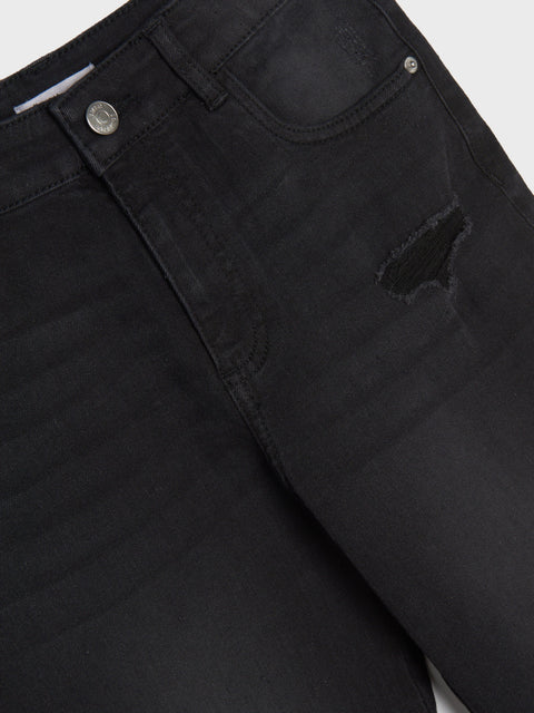 Close-up of black jeans with a button and zipper detail on a white background