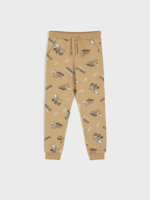 Beige jogger pants with vehicle pattern on a white background
