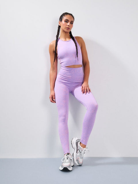 Woman wearing a purple athletic outfit on a white background