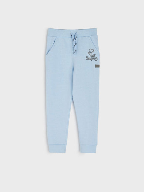 Light blue jogger pants with text on a white background