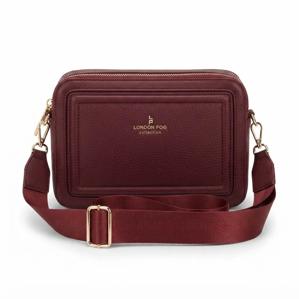 A burgundy pebbled leather crossbody camera bag with a matching adjustable webbing strap and gold-tone hardware, featuring the 'LONDON FOG collection' logo on the front, set against a plain white background.