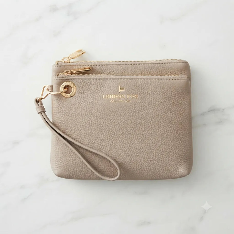 A taupe pebbled leather wristlet clutch with gold-tone hardware, featuring a wrist strap, a top zipper, and a horizontal card slot. The brand name 'LONDRENE COLLECTION' is embossed on the front, set against a white marble background.