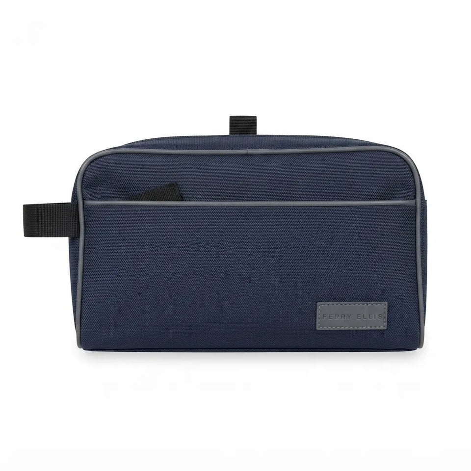 A navy blue textured canvas toiletry bag with a front slip pocket, a top carry loop, and a small grey brand patch on the lower right corner, shown against a plain white background.