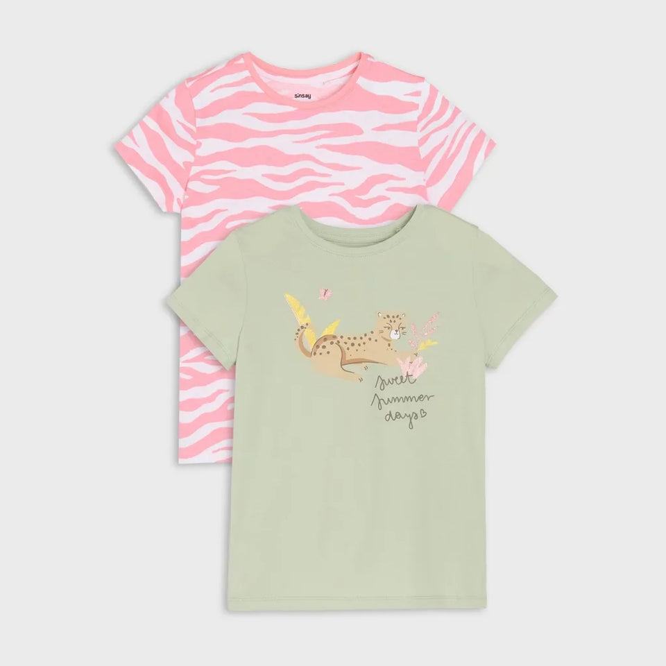 Two children's short-sleeve T-shirts shown on a light gray background. The top shirt is pink and white zebra-striped, and the bottom shirt is pale sage green with a cartoon cheetah graphic and the words 'Jewish summer days' on the front.