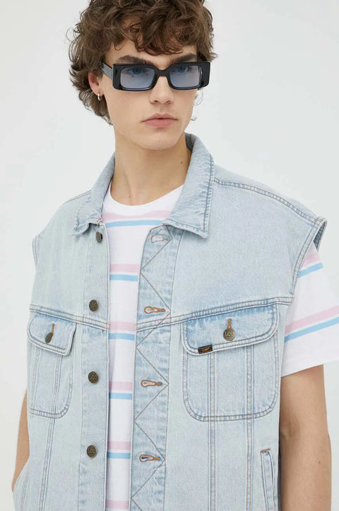 Person wearing a light blue denim vest over a striped shirt with a plain background