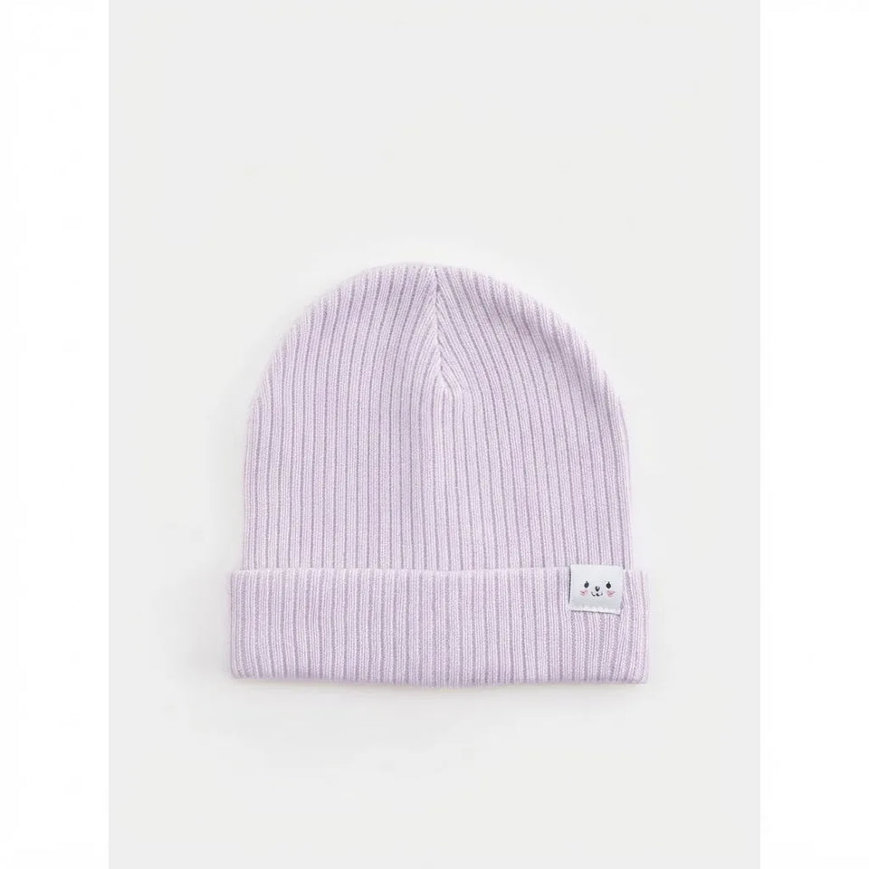 A light purple ribbed knit beanie hat with a folded cuff and a small white embroidered patch featuring a cute face on the side, set against a plain white background.