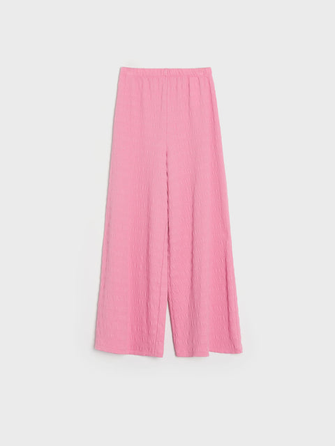 Pink wide-leg pants on a light gray background