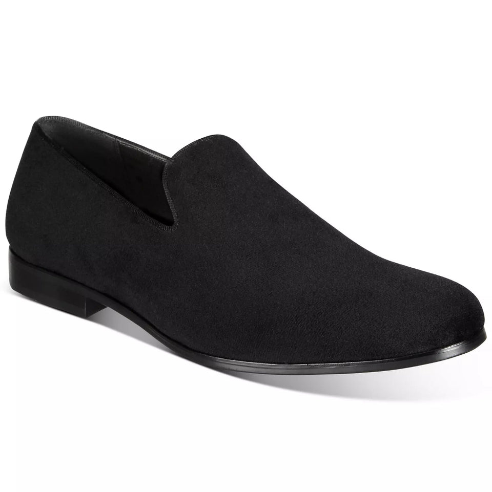 Black slip-on shoe on a white background