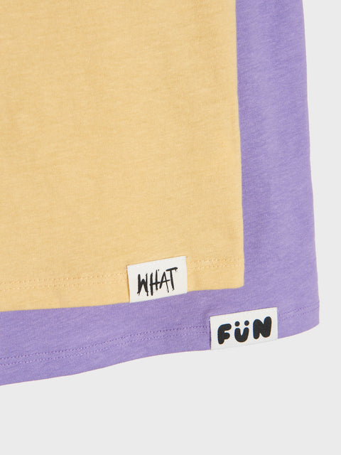 Close-up of a beige and purple fabric with 'WHAT' and 'FUN' labels.