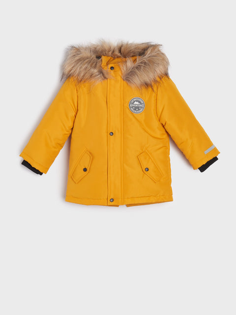Yellow winter coat with fur hood on a white background